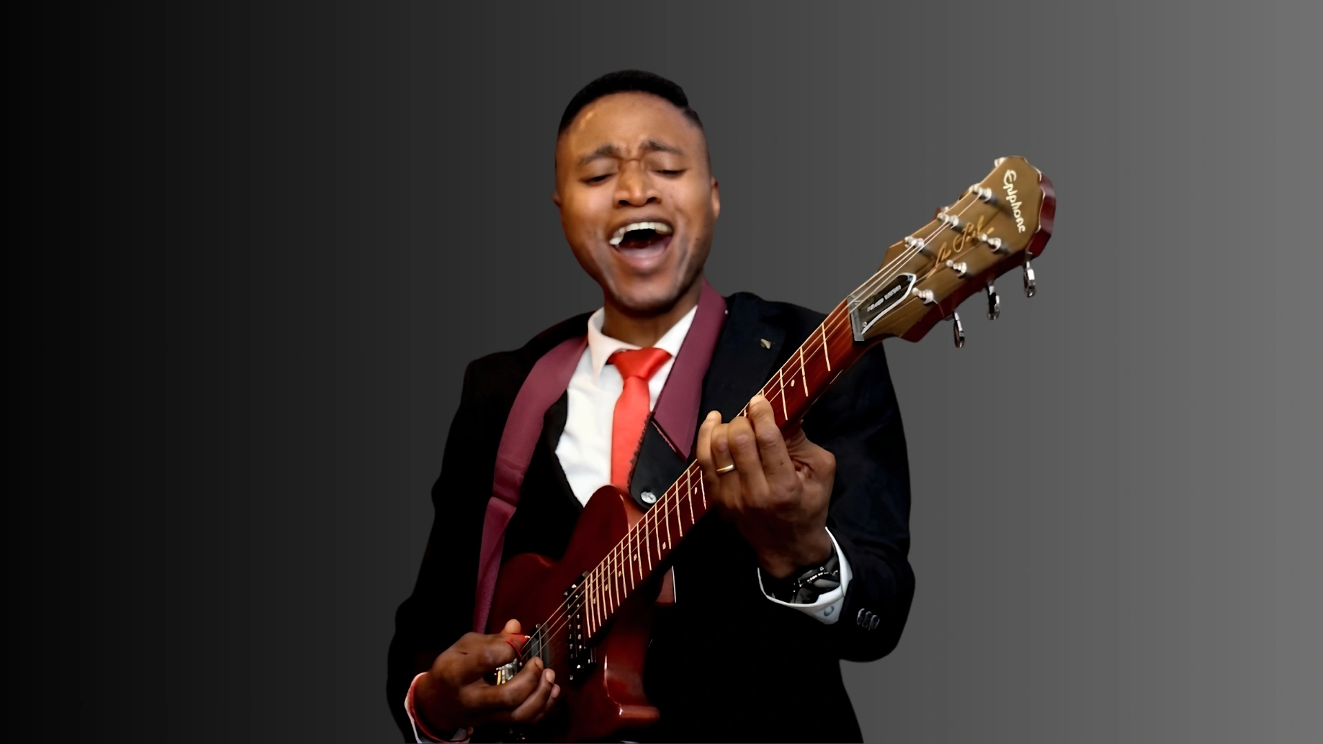 Kolade Adekunle playing a guitar